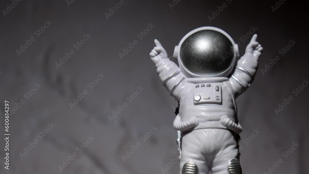 Zoom in out Plastic toy figure astronaut on moon concrete background Copy space. Concept of out of earth travel, private spaceman commercial flights. Space missions and Sustainability Zoom in out Plastic toy figure astronaut on moon concrete background Copy space. Concept of out of earth travel, private spaceman commercial flights. Space missions and Sustainability
