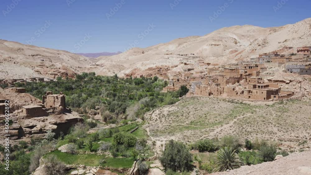 Atlas mountains landscape in Morocco African desert with stone village during a sunny day Atlas mountains landscape in Morocco African desert with stone village during a sunny day