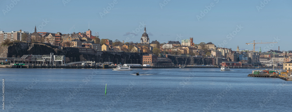 Panorama view over the bay Strömmen and the district Södermalm, archipelago commuter ferries leaving the down town, a sunny early tranquil summer day in Stockholm