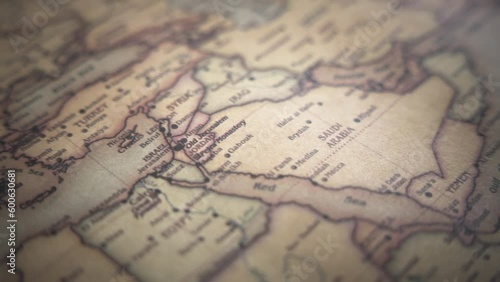 Middle East (Israel, Syria, Egypt, Jordan, Lebanon, Iraq, Saudi Arabia) on a vintage political world map. Slow motion, tracking arc shot. 