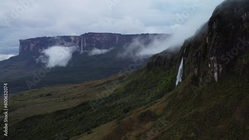 Aerial view of part of the Roraima tepuy wall with a waterfall and Kukena tepuy in the background. photo