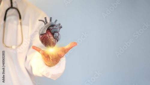 Fototapeta Naklejka Na Ścianę i Meble -  Doctor holding a virtual heart. healthcare, the hospital service concept