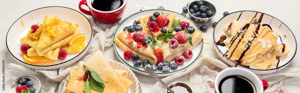 Sweet crepes assortment with berries chocolate on gray background. Homemade food concept. Top view, flat lay Sweet crepes assortment with berries chocolate on gray background. Homemade food concept. Top view, flat lay