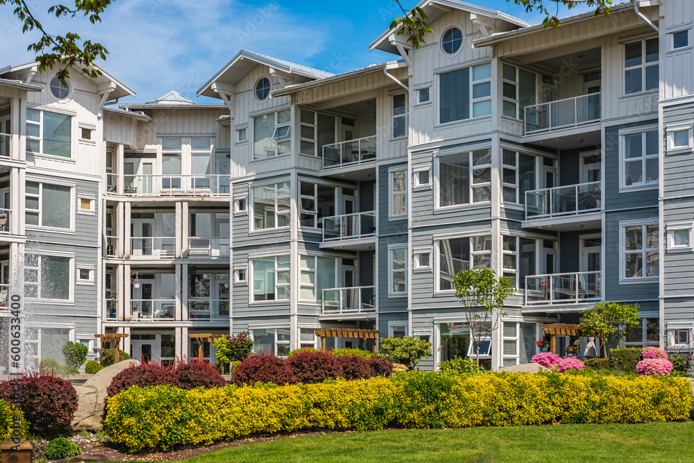 Facade of new residential townhouses. Apartment buildings in Canada. Modern complex of apartment buildings in spring