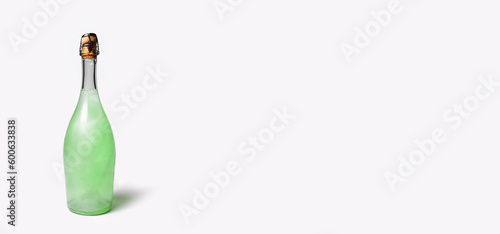 Close-up of green champagne bottle isolated on white background with copy space. Unusual alcohol drink. Panoramic banner view. Empty blank.