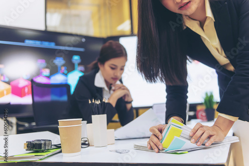 Businesswoman hands working in Stacks of paper files for searching and checking unfinished document achieves on folders papers.