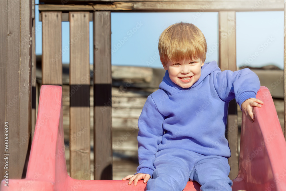 Portrait of a cute little boy laughing. The child smiles at the playground, sunny day. Portrait of a cute little boy laughing. The child smiles at the playground, sunny day.