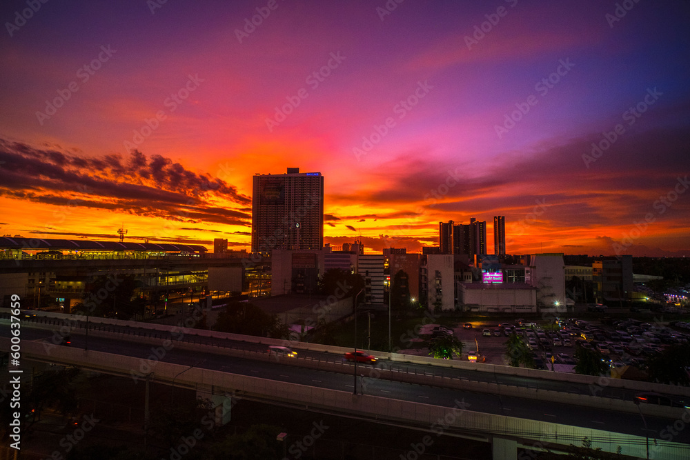 Dusk's Radiance: Cityscape Silhouette against a Dramatic Pink and Orange Sky