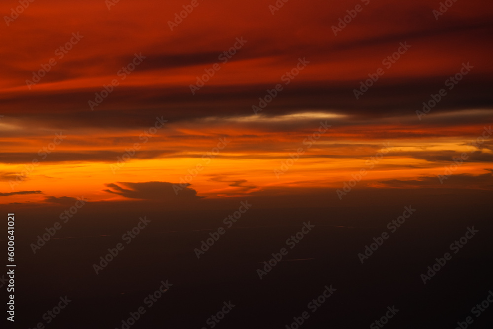 Dramatic sunset sky with orange red and blue shades. Aerial sunset landscape photo.