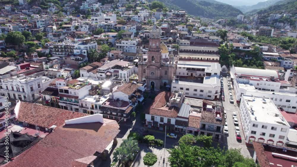 Drone flight from the Puerto Vallarta boardwalk to the town's church, focused on the church as the main point of interest, showcasing the city and mountains in the background. Drone flight from the Puerto Vallarta boardwalk to the town's church, focused on the church as the main point of interest, showcasing the city and mountains in the background.