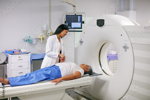 Doctor, mri and woman holding hands of patient in hospital before scanning in machine. Ct scan, comfort and medical professional with senior female person in radiology test for healthcare in clinic. photo