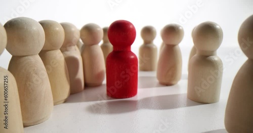 Wooden figurines crowd and one special. Stand out from crowd concept