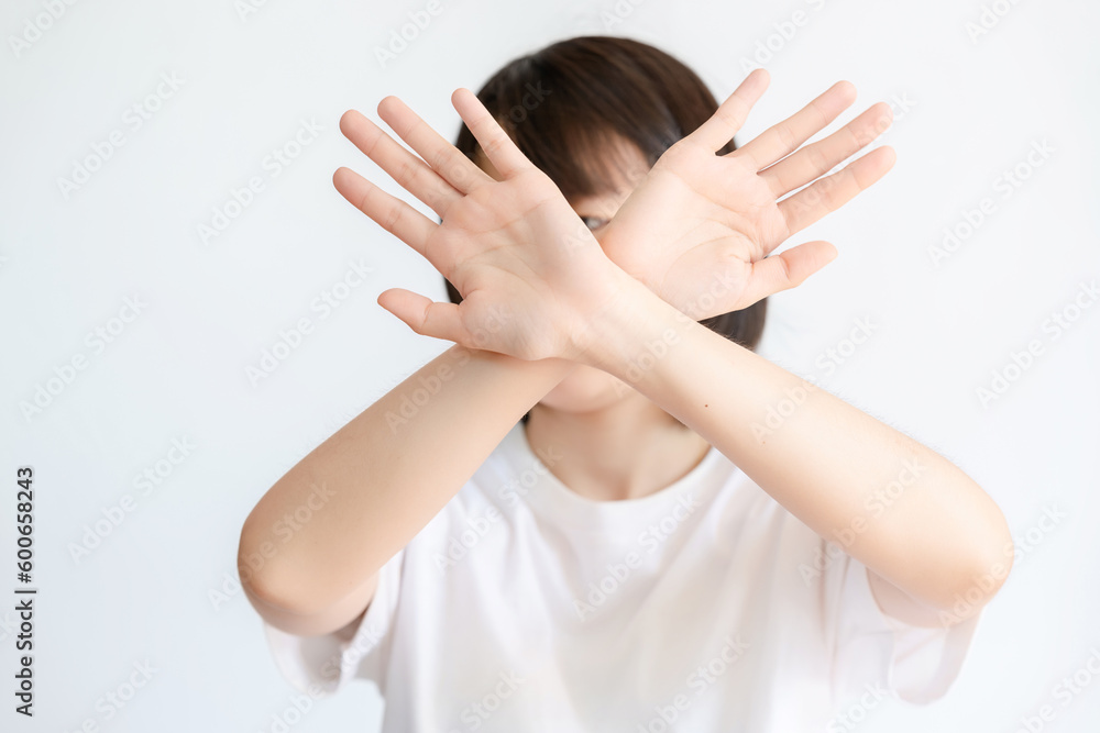 A woman showing a gesture of refusal due to dislike. A woman showing a gesture of refusal due to dislike.