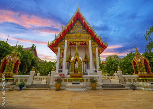 Beautiful Wat Buddhist temples in Phuket Thailand. light up at night and Decorated in beautiful ornate colours of red and Gold and Blue. Lovely sunset © Elias Bitar