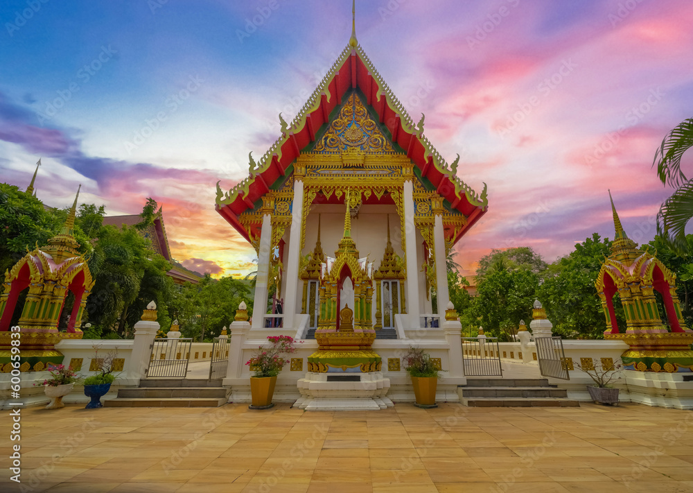 Beautiful Wat Buddhist temple in Phuket Karon Thailand. Decorated in beautiful ornate colours of Gold blue green red and White. Sunset Sunrise lovely sky and cloud colours Beautiful Wat Buddhist temple in Phuket Karon Thailand. Decorated in beautiful ornate colours of Gold blue green red and White. Sunset Sunrise lovely sky and cloud colours