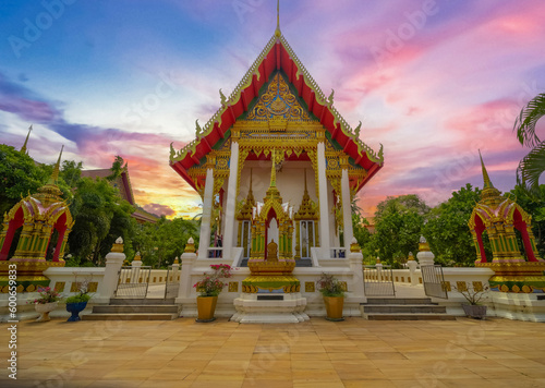 Beautiful Wat Buddhist temple in Phuket Karon Thailand. Decorated in beautiful ornate colours of Gold blue green red and White. Sunset Sunrise lovely sky and cloud colours © Elias Bitar