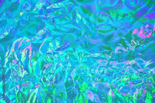 Abstract holographic background in 80s, 90s style. Modern pastel green, blue, mint, turquoise crumpled metallic psychedelic holographic foil texture. Vaporwave, psychedelic retro futurism, syberpunk