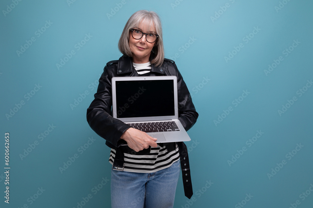 smart 60s mature old business woman with gray hair using laptop with mockup on bright background smart 60s mature old business woman with gray hair using laptop with mockup on bright background