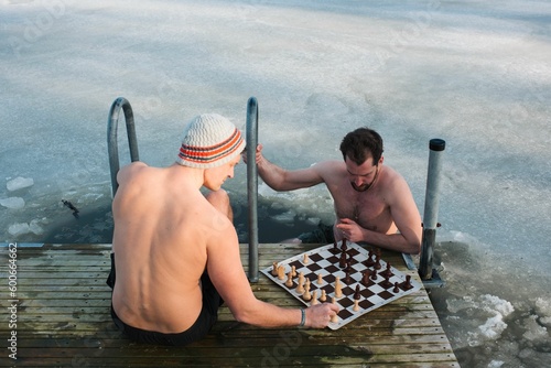 two men playing chess whilst cold water swimming in the Baltic Sea