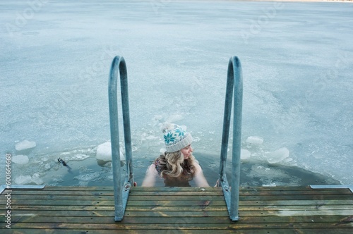 woman taking a dip in the frozen Baltic Sea in Scandinavia