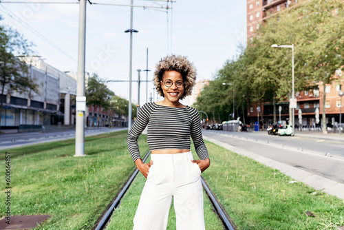 Portrait of Afro-American woman posing in the street with white pants