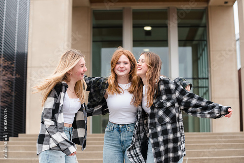Wallpaper Mural Three laughing teen girls hugging outdoors on steps. Torontodigital.ca