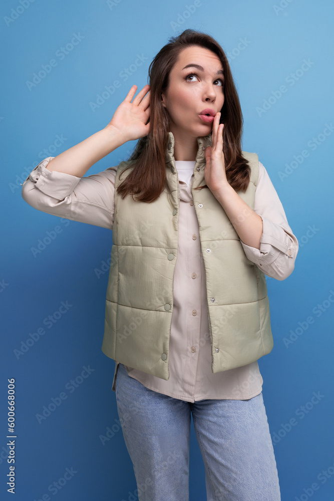 pretty european brunette young woman in vest and shirt on studio background pretty european brunette young woman in vest and shirt on studio background