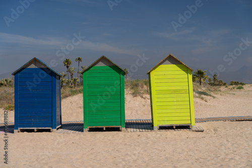 The wind on the seashore in Spain in spring. Bright colourful beach houses on the sandy beach. Castellon © victorgrow