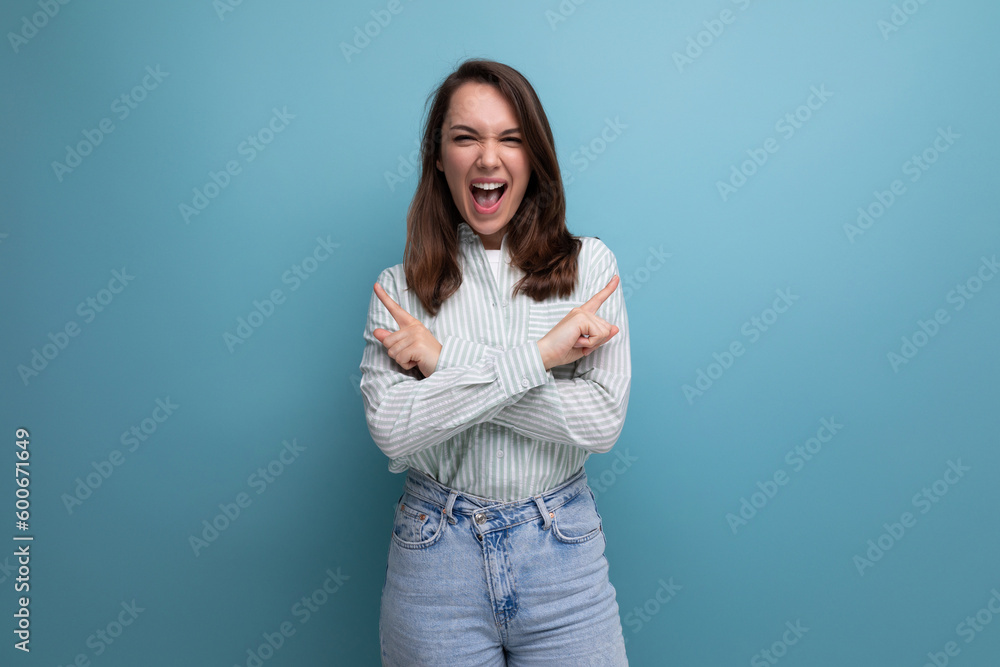 Obraz premium 25 year old brown-haired female person with crossed arms laughing out loud on a blue background