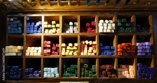 Shelving with sticks of colored lacquer wax for stamps and letters.