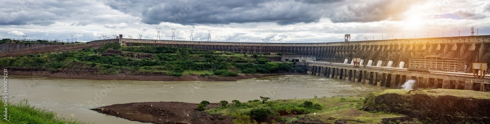 Panoramic view of modern giant dam on Parana river, South America. Itaipu Binacional hydroelectric power station in Foz do Iguazu Brazil, border Paraguay. Hydro electrification concept. Copy ad space