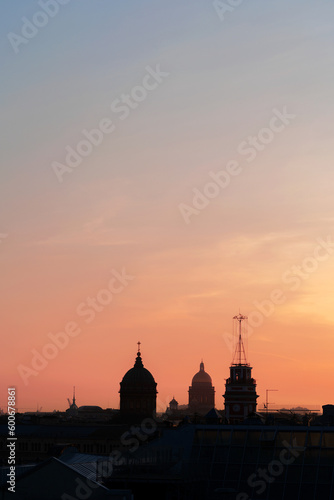 Panoramic view of the roofs, towers, domes of churches and cathedrals silhouetted against sunset light on spring evening. Saint-Petersburg, Russia. Travelling and tourism concept. Copy space.