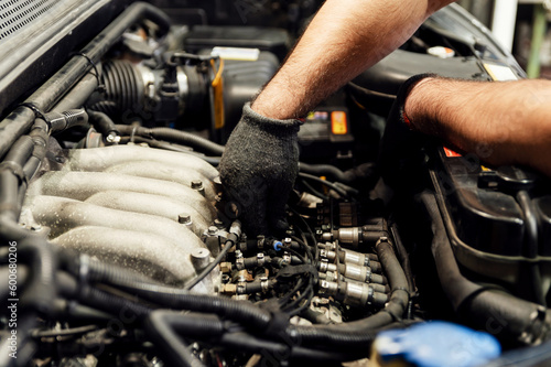 Auto mechanic modify the engine of an SUV in the garage. Work process. car maintenance. troubleshooting engine problems