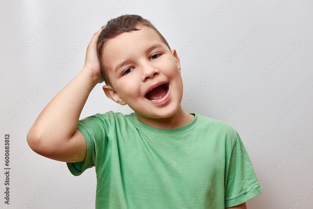 Handsome cheerful boy smiling with open mouth and holding his head. Handsome cheerful boy smiling with open mouth and holding his head.
