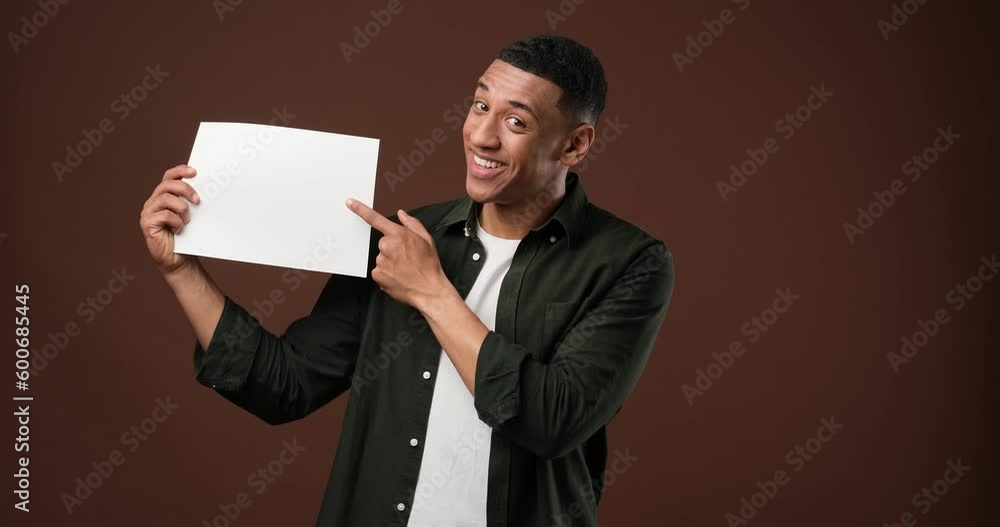 Happy smiling young handsome African american man holding white board Happy smiling young handsome African american man holding white board