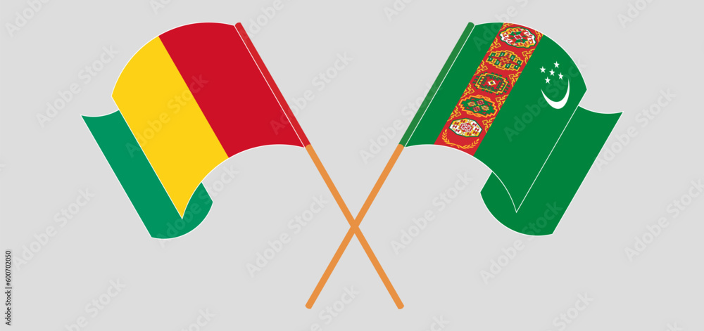 Crossed and waving flags of Guinea and Turkmenistan Crossed and waving flags of Guinea and Turkmenistan