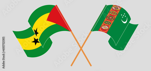 Crossed and waving flags of Sao Tome and Principe and Turkmenistan