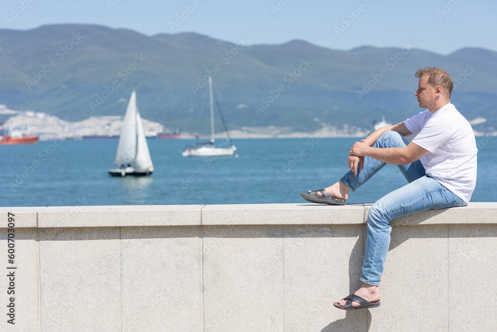 Young man on the embankment Young man on the embankment