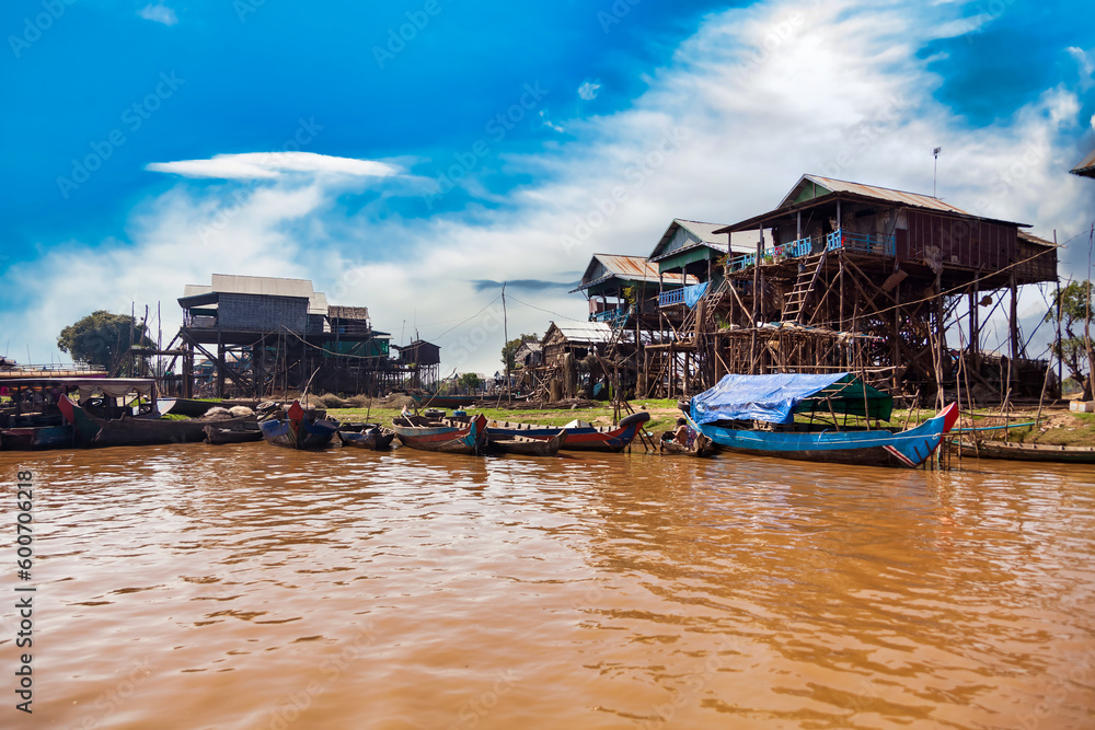 Life and work cambodian people, residents poverty country Cambodia. Tonle Sap lake, boats and houses on stilts on rural river in drought season, Kompong Phluk floating fishing village. Copy text space