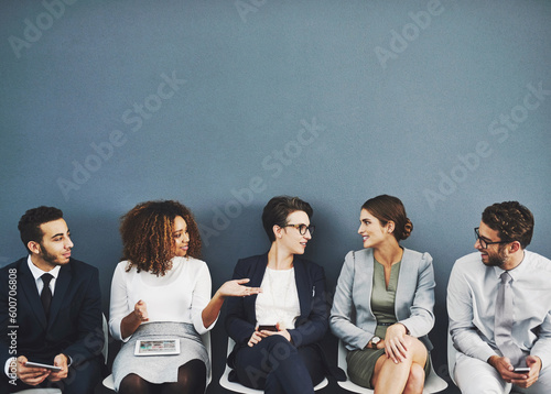 Business people, we are hiring and conversation before a job interview waiting and sitting in line. Communication, technology and staff with diversity and discussing for recruit meeting with mockup
