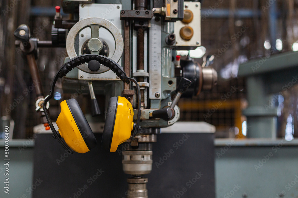 Soundproof headphones for industry plants hanging on lathe in factory ...