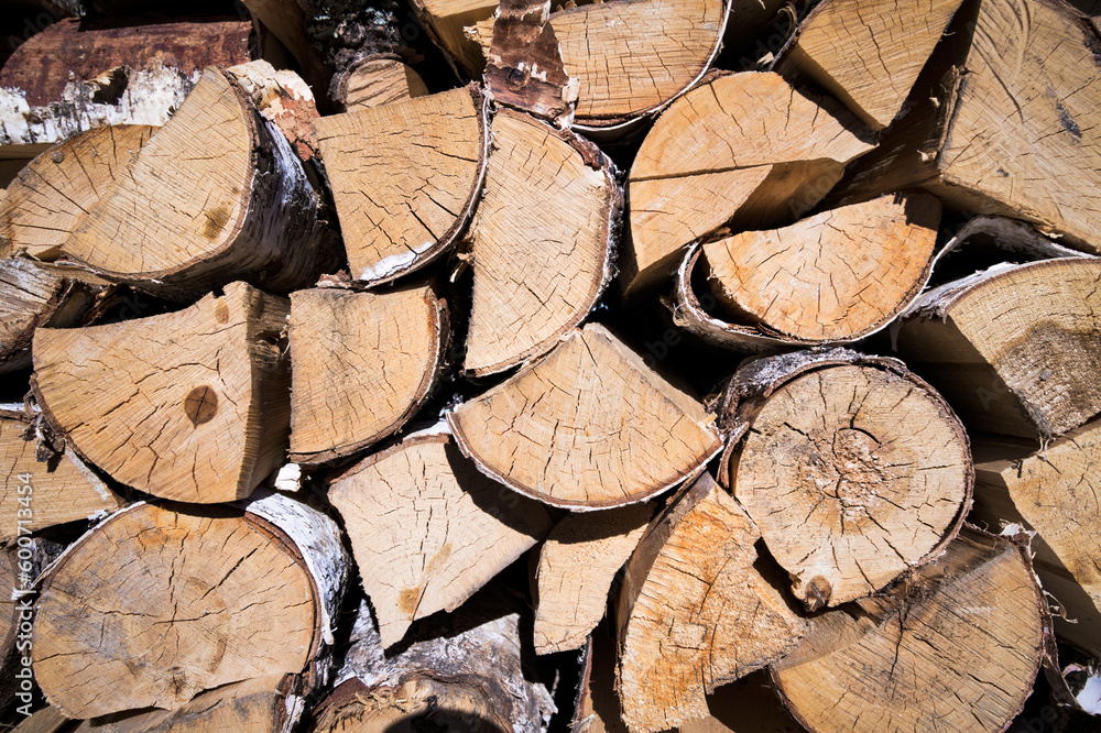 Birch firewood stacked in a woodpile Birch firewood stacked in a woodpile