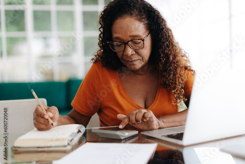 фотографія Senior black woman calculating her retirement annuity at home