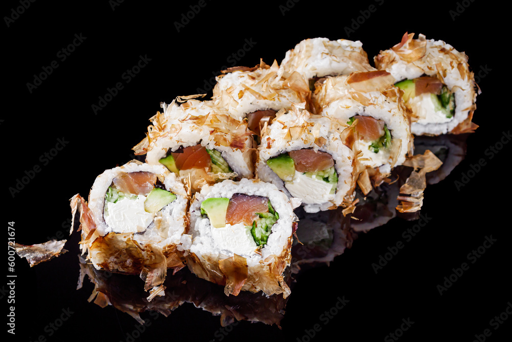 sushi roll with salmon cream cheese tuna avocado and cucumber on a black mirror background sushi roll with salmon cream cheese tuna avocado and cucumber on a black mirror background