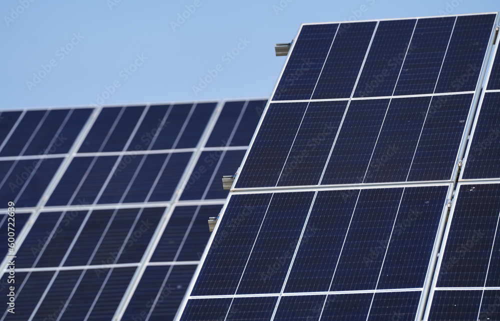 Wide angle selective focus concept photo with some big solar panels. Photovoltaic electrical energy industry, eco friendly way to produce electricity from sun. Wide angle selective focus concept photo with some big solar panels. Photovoltaic electrical energy industry, eco friendly way to produce electricity from sun.