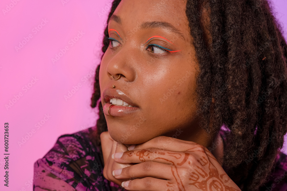 Young woman wearing pink eyeliner and piercings Young woman wearing pink eyeliner and piercings