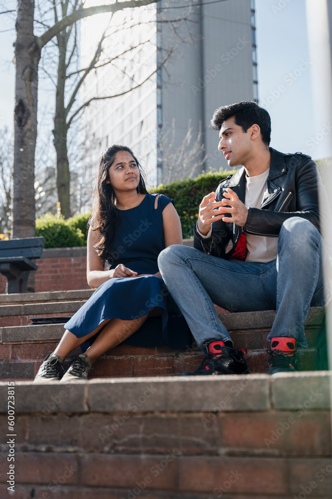 Smiling young student sitting on campus Smiling young student sitting on campus