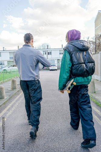 Young male friends walking outdoors