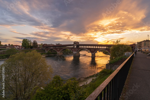 Ponte Coperto (covered bridge) over Ticino river in Pavia at sunset, Lombardy, italy.