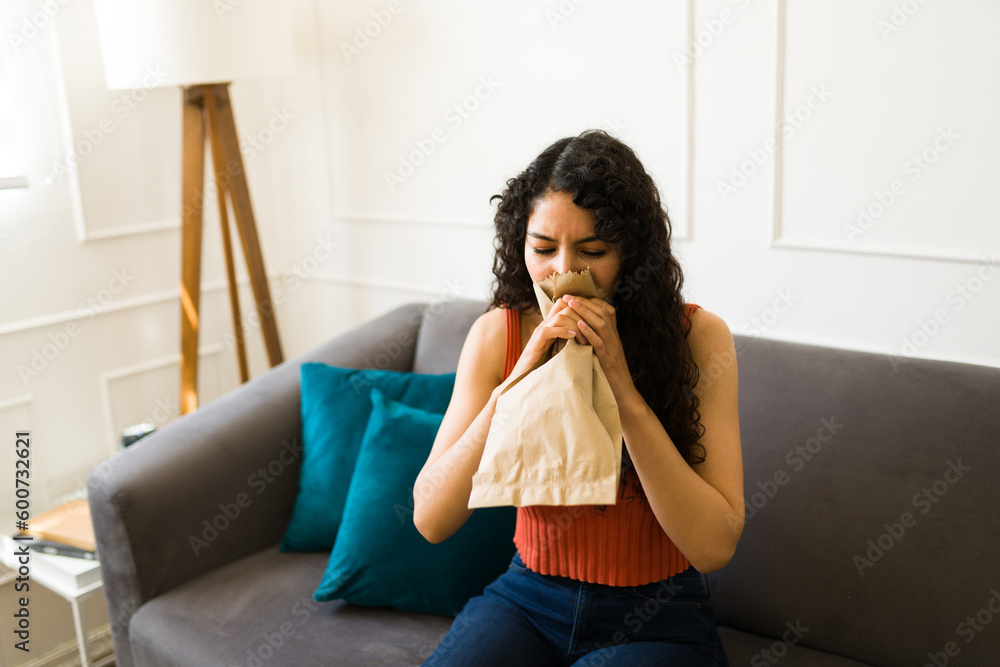 Sick latin woman suffering from anxiety and having breathing problems Sick latin woman suffering from anxiety and having breathing problems